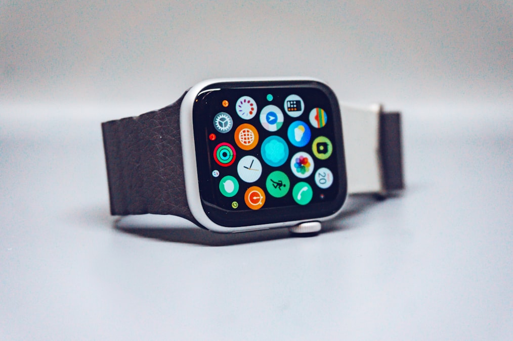 A smartwatch with a dark textured band and a colorful app icon display