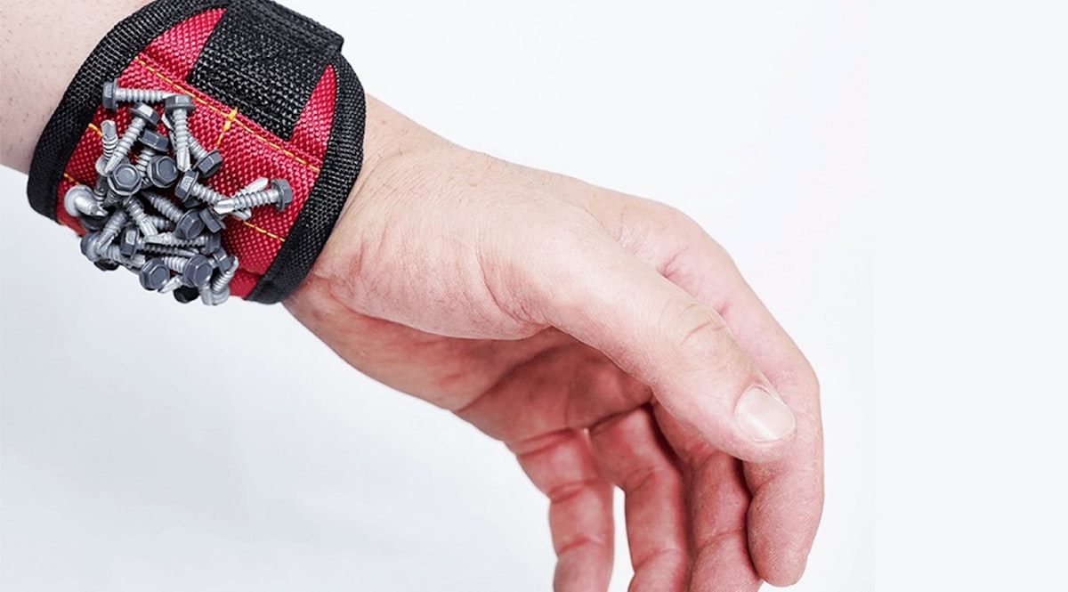 A hand holding a bunch of screws on it's wrist