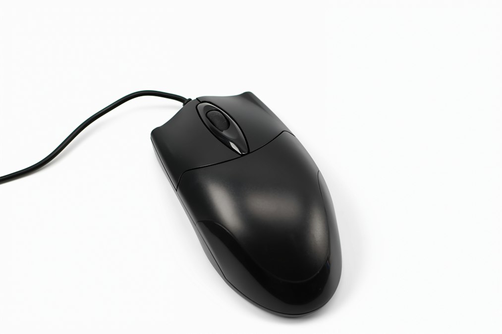 A black computer mouse with a cord